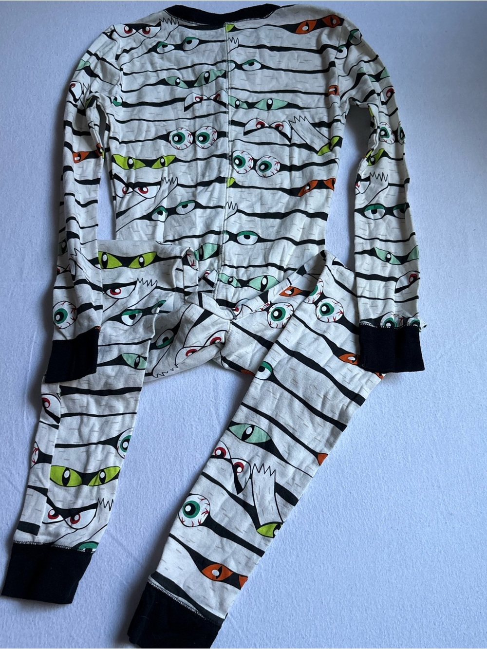 Old Navy White Kids Pajama Set with Black Trim and Multi-Colored Eye Print